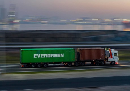 Lorry on the road from Euromax Terminal Rotterdam, ENECO wind farm on the dike around the port of