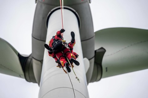 Height rescuers from the Gelsenkirchen fire brigade practise abseiling from a wind turbine from a