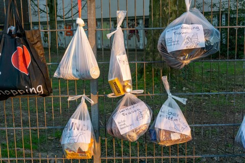 Gift fence with donations for the homeless and needy, food, hygiene articles, clothing, in Essen