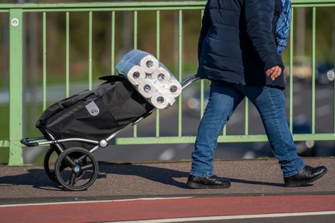 Effects of the coronavirus crisis, woman bought a large pack of toilet paper, Cologne, Germany,