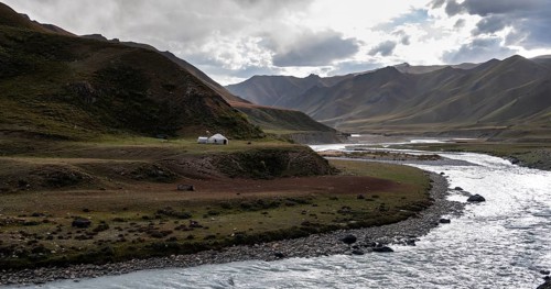 Yurt by a river, Desolate mountain landscape, Tian Shan, Sky Mountains, Sary Jaz Valley,