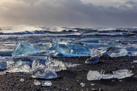 Ice floes on the beach, waves, sea, clouds, sunlight, winter, Diamond Beach, Breidamerkursandur,