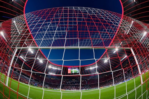 Overview, interior, floodlit match, behind-the-goal perspective, goal net, blue hour, fisheye shot,