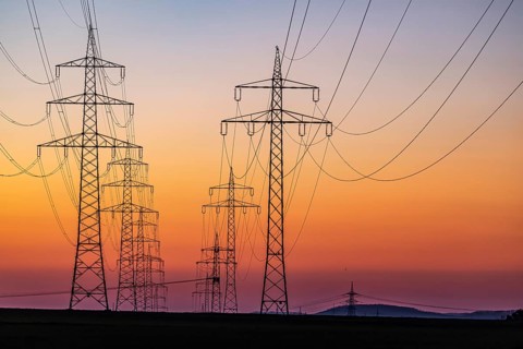 High-voltage pylons, overhead power lines at sunset. Schwieberdingen, Baden-Württemberg, Germany,