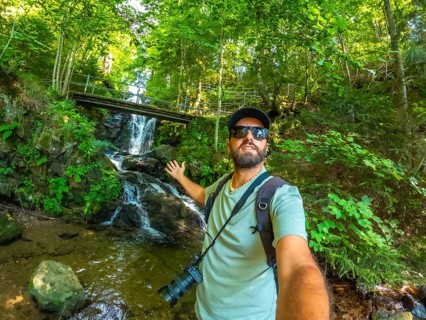 Selfie of a man tourist hiker in summer at Todtnau waterfall in Black Forest in Germany