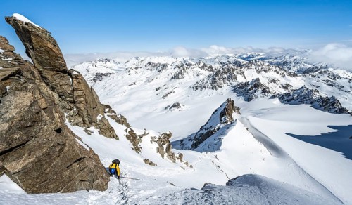 Mountaineer with ice axe and crampons, ascent through steep snowfield to Piz Kesch or Piz d'Es-cha