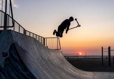 Skater, scooter in a halfpipe at the beach of Scheveningen, sunset, Netherlands