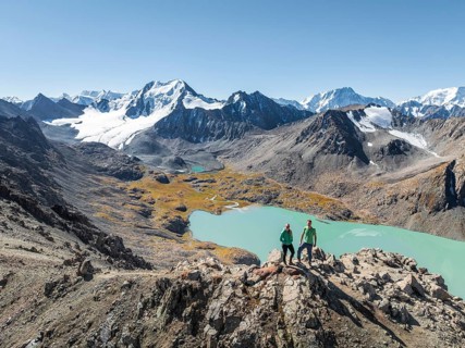 Hiker at the pass at 4000m, aerial view, mountains with glacier, mountain pass and mountain lake