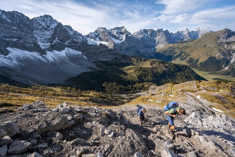 Two mountaineers on a hiking trail, mountain panorama with rocky steep peaks, view of summits