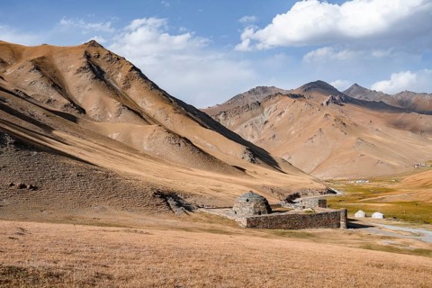 Historic caravanserai Tash Rabat from the 15th century, with yellow hills, Atbashy district in the