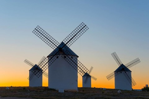 Windmills silhouetted against a soft evening sky, Campo de Criptana, Ciudad Real province,