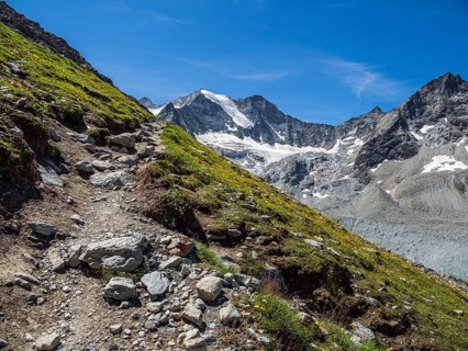 Hiking path up to mountain hut Cabane de Moiry, Moiry glacier in the back, Valais, Switzerland,