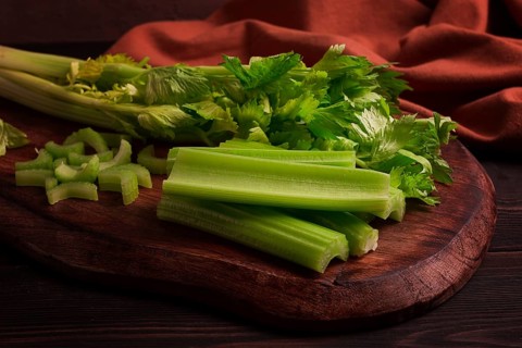 Fresh bunch of celery, top view, no people, on a dark background