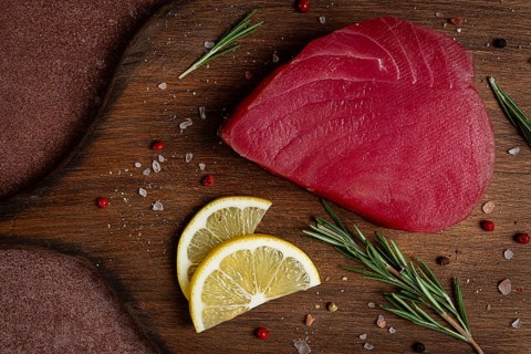 Fresh red tuna fillet, for steak, raw, top view, on a cutting board, no people
