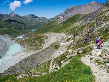 Hiking trail up to mountain hut Cabane de Moiry, glacial moraine, lake Lac de Moiry in the back,
