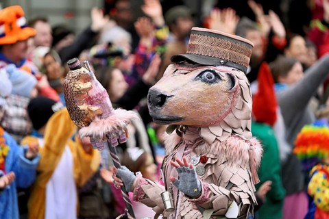 Person masked as a horse with a hat at the carnival parade of the Wey guild on Rose Monday,