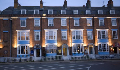 Row of guest houses and small hotels at night on the Esplanade, Weymouth, Dorset, England, United