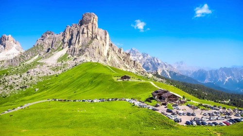 Panoramic view capturing the mountain shelter and parking area at passo giau in the italian