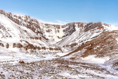 The beautiful Hengifoss waterfall frozen in the cold winter of Iceland, volcanic cliffs