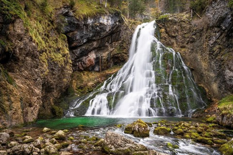 The Golling waterfall (Schwarzbachfall, Schwarzenbachfall) in autumn. Rocks with moss. Tennengau,