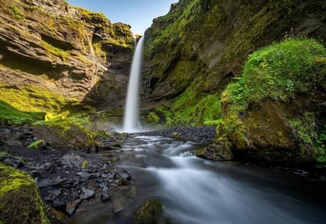 Kvernufoss waterfall, in summer when the weather is fine, gorge and river, long exposure, Skogar,