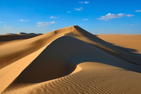 Large sand dune with soft shadows and glowing light accents in a desert landscape, Matruh, Great