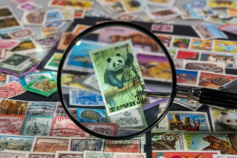 Stamp collection, collecting, postage stamps, postage stamps from different countries, magnifying