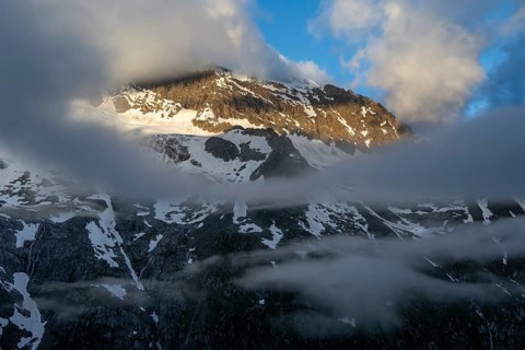 Cloudy mountain landscape in dramatic morning light, Griesferner peak with snow, Berliner Höhenweg,