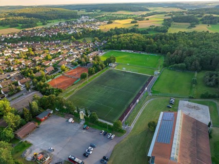 Aerial view of a village with a large sports field, football pitches and tennis courts, Gechingen,