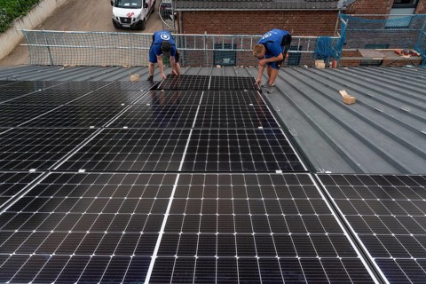 Installation of solar modules on the roof of a barn on a farm, over 240 photovoltaic modules are