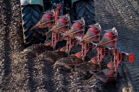 Farmer ploughing a field, tractor with plough, near Neuss, North Rhine-Westphalia, Germany, Europe
