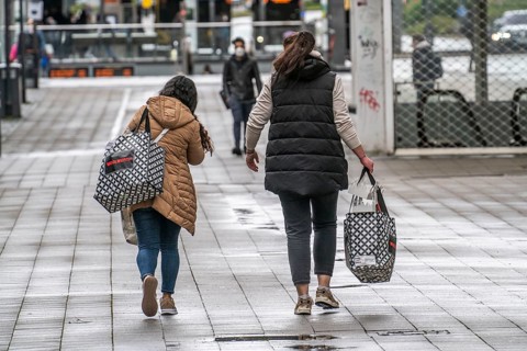 Shoppers on Kettwiger Straße, Essen city centre, with shopping bags from the Woolworth department