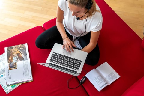 Young student learns at home, online, in conversation with other students