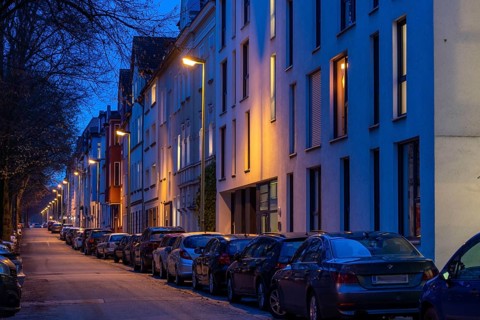 Residential street, many apartment buildings in a residential neighbourhood, evening, lantern