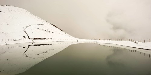 Onset of winter in May, Riezler Alpsee, an artificial lake, snow pond, feeds the snow cannons that