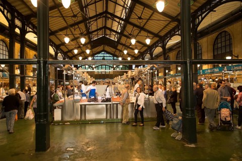 People shopping at fishmonger stalls inside historic covered market building, Jerez de la Frontera,
