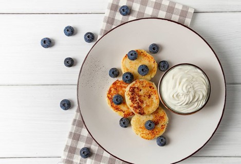 Cottage cheese pancakes, with blueberries, breakfast, on a white wooden table, no people, top view