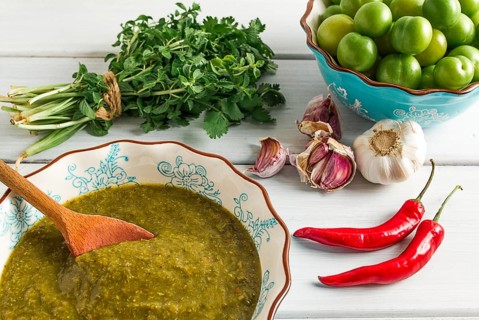 Tkemali sauce, traditional Georgian cuisine, green cherry plum, with ingredients for sauce,
