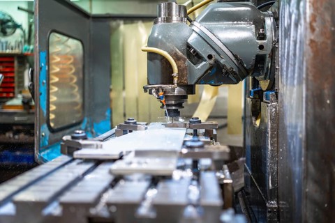 Milling machine molding shapes in metal pieces in a cnc factory with no people