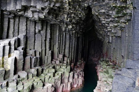 Dark cave with impressive basalt columns and deep water in a natural setting, Staffa, Inner