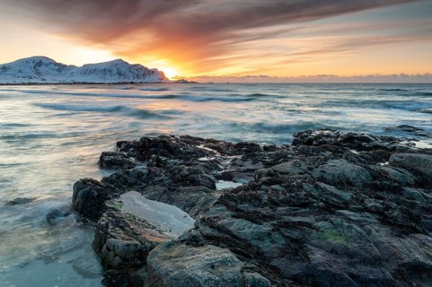 Long exposure, sunset in winter at Skagsanden, rocks on the beach at Flakstad, Flakstadøy, Lofoten,
