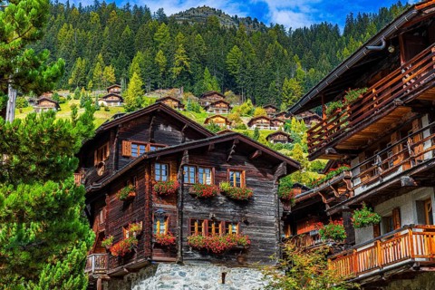 Wooden houses decorated with flowers in the historic village centre, Grimentz, Val d'Anniviers,