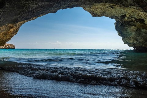 Turquoise waves gently washing onto the shore of cala domingos beach in mallorca, spain, viewed