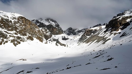 High mountain valley with mountain peak Piz Calderas in winter, view at the Chamanna Jenatsch in