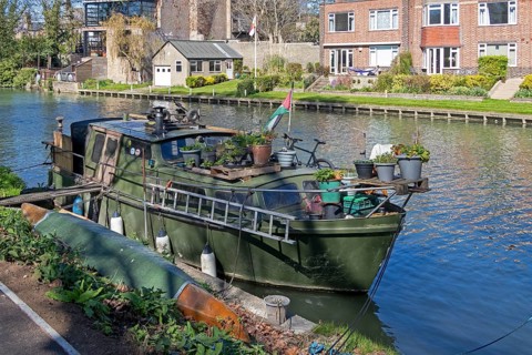 Old boat lying on the bank, River Cam, Cambridge, England, Great Britain