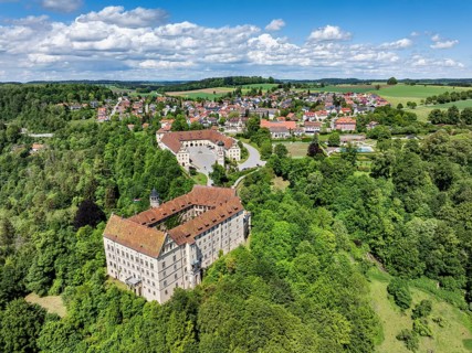 Aerial view of Heiligenberg Castle, a Renaissance-style castle complex, behind it the municipality