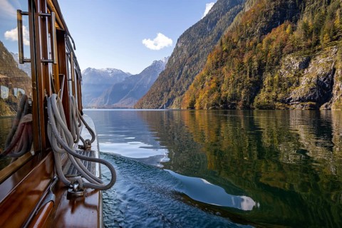 Tourist boat on the Königssee, autumnal mountain landscape reflected in the lake, Berchtesgaden