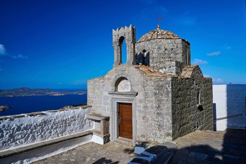 Historic chapel on a hill overlooking the sea under a clear sky, Agiou Theologou Monastery, St