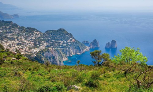 View from Monte Solaro 589m to the south coast with the Faraglioni rocks, the island's landmarks,