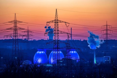 Digesters of the Emscher sewage treatment plant Bottrop, illuminated, high-voltage pylons, North